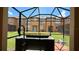 Relaxing hot tub on patio with screened enclosure at 2716 Bushman Dr, Kissimmee, FL 34746