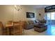 Bright living room with dining area, comfy couch, and access to patio at 2716 Bushman Dr, Kissimmee, FL 34746