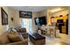 Open concept kitchen and living area, features breakfast bar and large TV at 2716 Bushman Dr, Kissimmee, FL 34746
