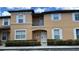 Tan two-story townhome with white trim at 2716 Bushman Dr, Kissimmee, FL 34746