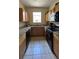 Galley style kitchen with granite countertops and black appliances at 2716 Bushman Dr, Kissimmee, FL 34746