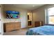 Bedroom with large TV, dresser, and en-suite bathroom at 2716 Bushman Dr, Kissimmee, FL 34746