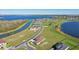 Aerial view of a lakefront community with new homes and lush landscaping at 267 Spinnaker Ct, Auburndale, FL 33823