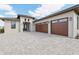 Modern home with a three-car garage and stone driveway at 267 Spinnaker Ct, Auburndale, FL 33823