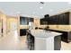 Modern kitchen with dark cabinetry, granite counters, and breakfast bar at 3425 Halsway Dr, Orlando, FL 32824