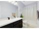Clean bathroom with a shower/tub combo and dark vanity at 3425 Halsway Dr, Orlando, FL 32824