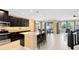 Kitchen with island, dark cabinets, granite counters and stainless steel appliances at 3425 Halsway Dr, Orlando, FL 32824