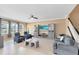 Bright living room featuring a large TV, comfortable seating, and a ceiling fan at 3425 Halsway Dr, Orlando, FL 32824