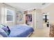 Bright bedroom with a queen bed and walk-in closet at 3425 Halsway Dr, Orlando, FL 32824