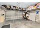 Garage with overhead storage racks and space for multiple vehicles at 3425 Halsway Dr, Orlando, FL 32824