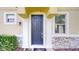 Dark gray front door with a stone and light yellow exterior at 14315 Swanley St, Orlando, FL 32832