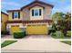 Two story home with stone and yellow siding, and a two car garage at 14315 Swanley St, Orlando, FL 32832