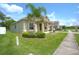 Tan house with palm tree and landscaping at 2461 Marshfield Preserve Way, Kissimmee, FL 34746