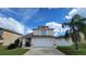 Two-story house with attached garage and palm tree at 3011 Bransbury Ct, Kissimmee, FL 34747
