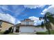 Two-story house with attached garage and palm tree at 3011 Bransbury Ct, Kissimmee, FL 34747
