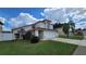 Two-story house with a garage and landscaped lawn at 3011 Bransbury Ct, Kissimmee, FL 34747