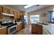 Spacious kitchen with stainless steel appliances and wood cabinets at 3011 Bransbury Ct, Kissimmee, FL 34747