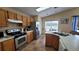 Spacious kitchen with stainless steel appliances and wood cabinets at 3011 Bransbury Ct, Kissimmee, FL 34747