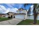 Two-story house with a white garage door and manicured lawn at 3011 Bransbury Ct, Kissimmee, FL 34747