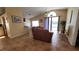 Living room with brown couches, a view of the pool and access to the kitchen at 3011 Bransbury Ct, Kissimmee, FL 34747