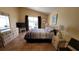 Main bedroom with large bed, dresser, and sliding glass doors to the patio at 3011 Bransbury Ct, Kissimmee, FL 34747