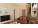 Living room with brown leather couches and a view of the staircase at 3011 Bransbury Ct, Kissimmee, FL 34747