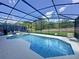 Enclosed pool and spa with a screened enclosure and backyard view at 416 Orange Cosmos Blvd, Davenport, FL 33837