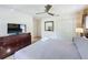 King-size bed, dresser, and TV in a spacious bedroom at 416 Orange Cosmos Blvd, Davenport, FL 33837