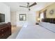 King-size bed, dresser, and TV in a spacious bedroom at 416 Orange Cosmos Blvd, Davenport, FL 33837