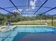 Inviting screened pool with lounge chairs and spa at 416 Orange Cosmos Blvd, Davenport, FL 33837