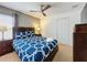 Bedroom with a double bed, dark brown dresser and ceiling fan at 416 Orange Cosmos Blvd, Davenport, FL 33837