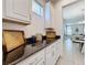 White kitchen cabinets and granite countertops with additional storage at 416 Orange Cosmos Blvd, Davenport, FL 33837