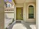 Inviting front door with arched entryway and a welcome mat at 416 Orange Cosmos Blvd, Davenport, FL 33837
