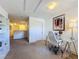 Home office with glass desk, white chair and built-in shelving at 416 Orange Cosmos Blvd, Davenport, FL 33837