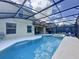 Enclosed pool area with patio furniture and a screened enclosure at 416 Orange Cosmos Blvd, Davenport, FL 33837