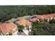 Aerial view of houses with orange tile roofs, showcasing a desirable community at 416 Orange Cosmos Blvd, Davenport, FL 33837