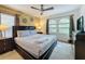 Spacious bedroom with king-size bed, large windows, and ceiling fan at 416 Orange Cosmos Blvd, Davenport, FL 33837