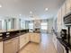 Open concept kitchen with island and breakfast area, showcasing granite countertops and modern appliances at 416 Orange Cosmos Blvd, Davenport, FL 33837