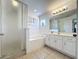 Bathroom with shower, bathtub, and vanity with white cabinets at 416 Orange Cosmos Blvd, Davenport, FL 33837