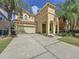 Two-story house with a two-car garage and palm trees at 416 Orange Cosmos Blvd, Davenport, FL 33837