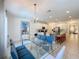 Open dining area with a glass table and view of the kitchen at 416 Orange Cosmos Blvd, Davenport, FL 33837