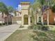 Two-story house with a two-car garage and palm trees at 416 Orange Cosmos Blvd, Davenport, FL 33837