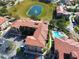 Aerial view showing apartment buildings, pool, and pond at 907 Charo Pkwy # 933, Davenport, FL 33897