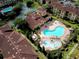 Aerial view of community pool, clubhouse, and surrounding buildings at 907 Charo Pkwy # 933, Davenport, FL 33897