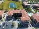 Aerial view of community featuring pool, pond, and building exteriors at 907 Charo Pkwy # 933, Davenport, FL 33897