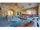 Relaxing community patio with stone accents, comfortable seating, and ceiling fans at 907 Charo Pkwy # 933, Davenport, FL 33897