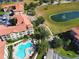 Aerial view of apartment buildings, pool, and pond at 907 Charo Pkwy # 933, Davenport, FL 33897