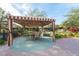 Striped-awning gazebo with table and chairs, perfect for outdoor dining at 907 Charo Pkwy # 933, Davenport, FL 33897