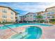 Community pool and spa with surrounding patio at 907 Charo Pkwy # 933, Davenport, FL 33897