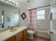 Bathroom with tub, shower, and wood vanity at 256 Sevilla Ave, Davenport, FL 33897
